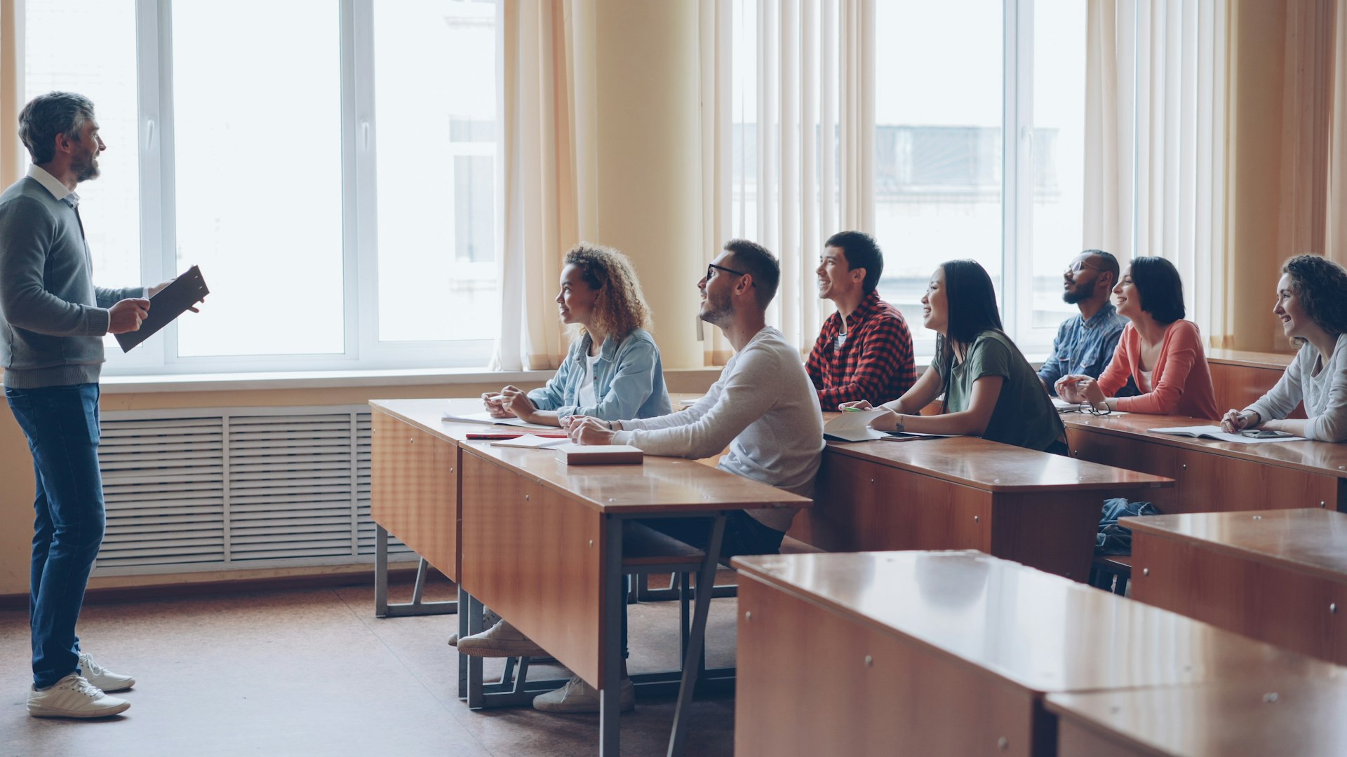 Professor lecturing to students in a classroom.
